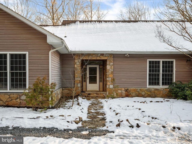 view of snow covered property entrance