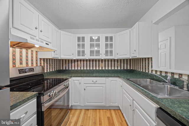 kitchen featuring white cabinetry, sink, stainless steel appliances, and light wood-type flooring