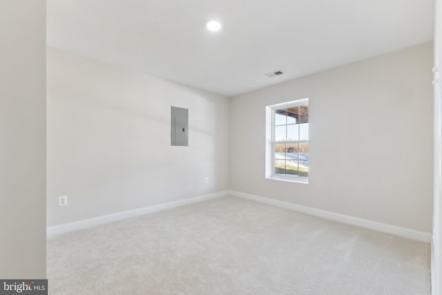 carpeted empty room featuring electric panel