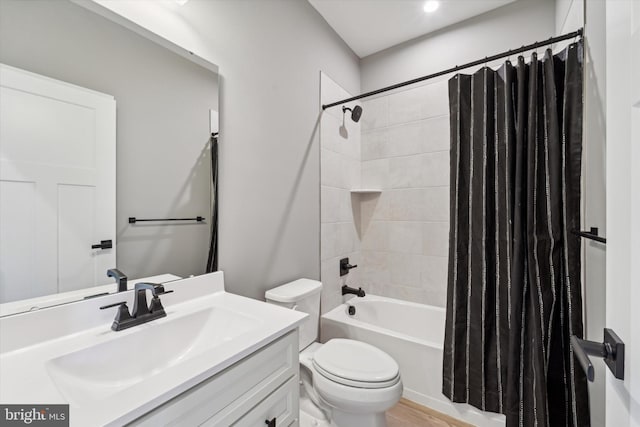 full bathroom with toilet, shower / tub combo with curtain, and vanity