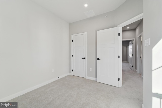 unfurnished bedroom with light carpet