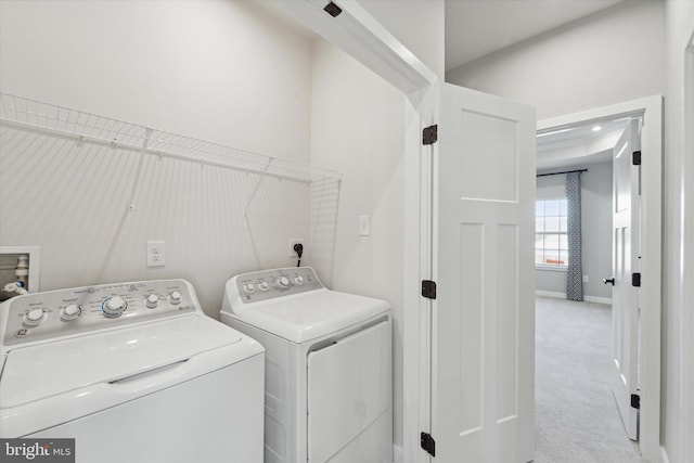 laundry room featuring washing machine and dryer and light carpet