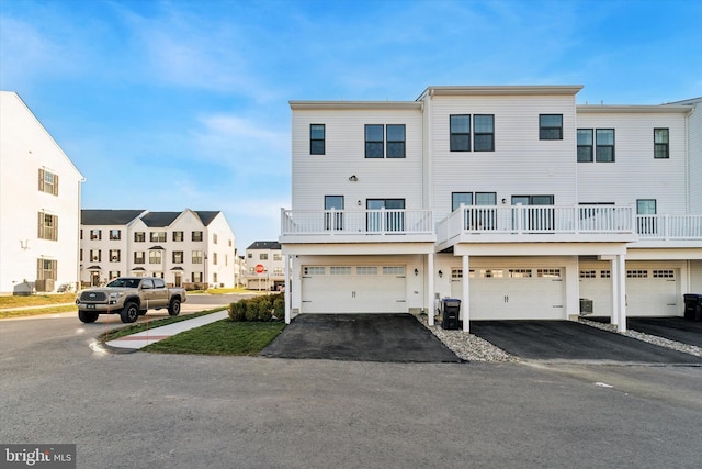 view of front of property featuring a balcony and a garage