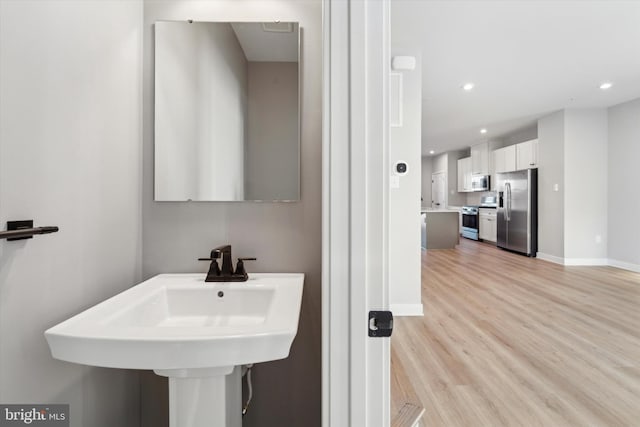 bathroom with sink and hardwood / wood-style flooring