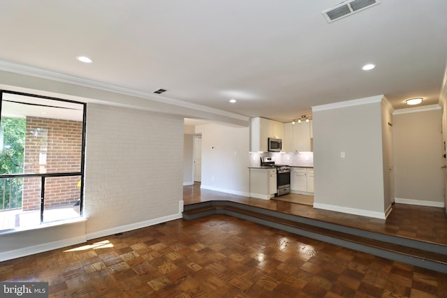 unfurnished living room with dark parquet floors and crown molding