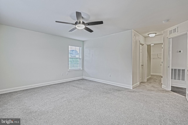 carpeted spare room with ceiling fan