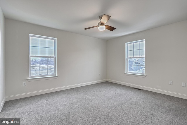 unfurnished room featuring ceiling fan and carpet flooring