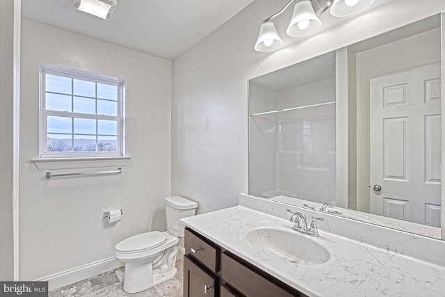 bathroom featuring toilet, walk in shower, and vanity