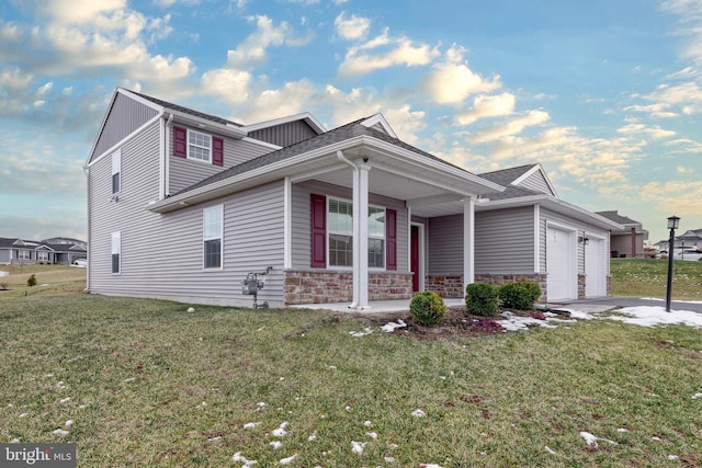 view of front of home featuring a garage, a front lawn, and a porch