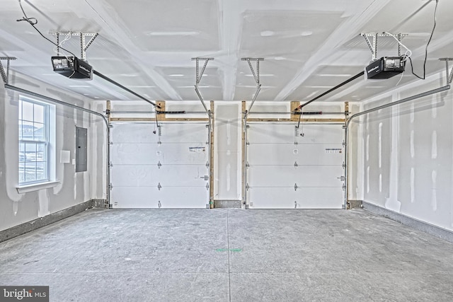 garage with a garage door opener and electric panel