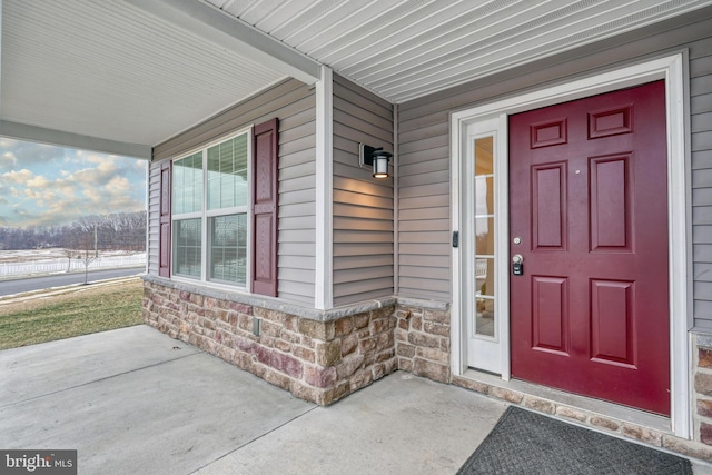 doorway to property featuring a porch