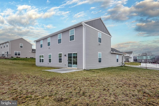 rear view of house featuring a patio area and a yard