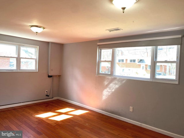 unfurnished room featuring hardwood / wood-style flooring