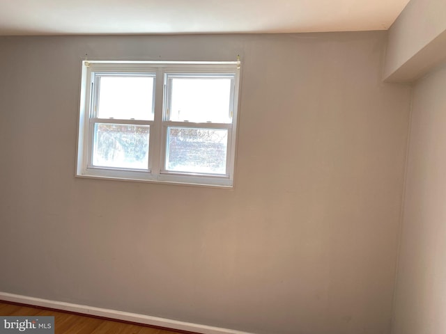 unfurnished room with hardwood / wood-style floors