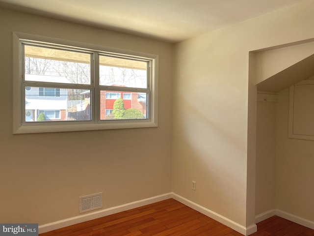 spare room with wood-type flooring