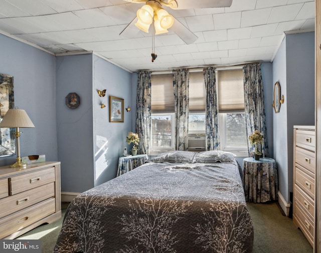 bedroom with ceiling fan and dark colored carpet