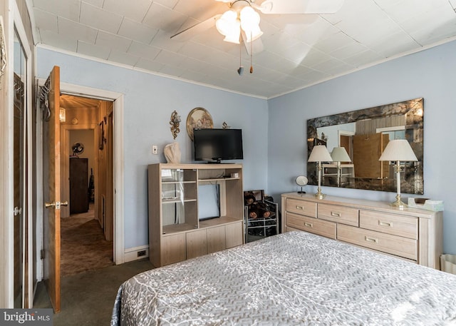 carpeted bedroom featuring ceiling fan and ornamental molding