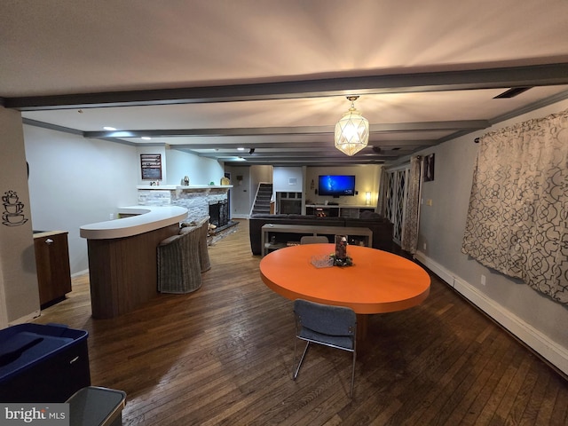 dining room with beamed ceiling and wood-type flooring