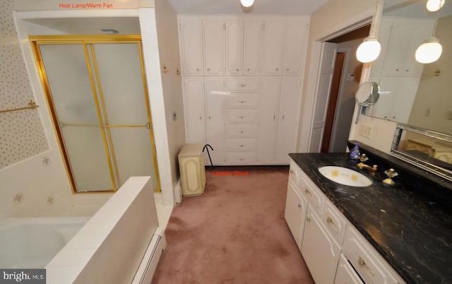 bathroom with a tub and vanity