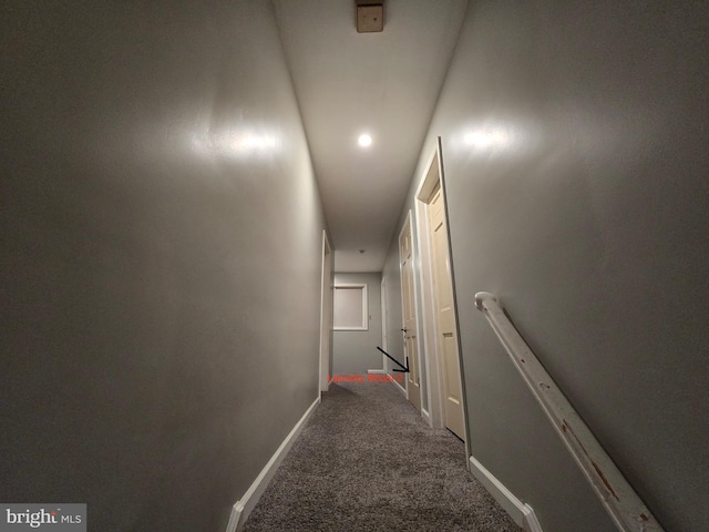 corridor with dark colored carpet