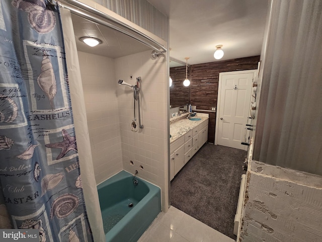 bathroom with wood walls, tile patterned floors, shower / tub combo with curtain, and vanity