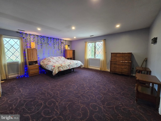 bedroom with baseboard heating and dark colored carpet