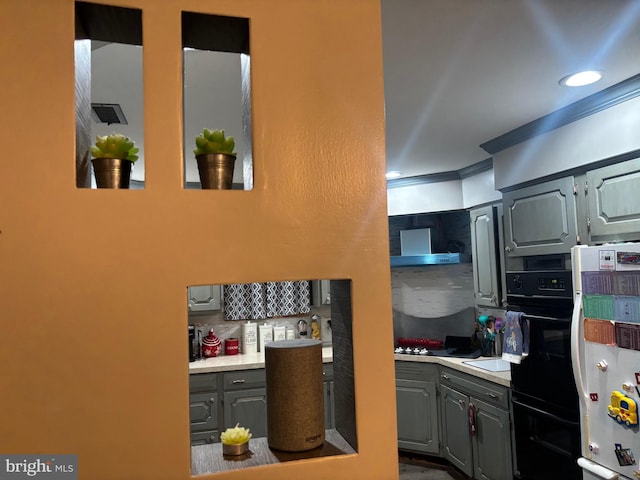 kitchen featuring extractor fan, tasteful backsplash, gray cabinetry, double oven, and white refrigerator