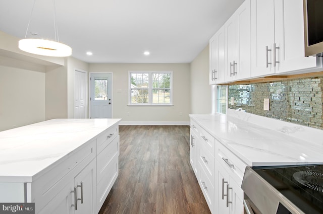 kitchen featuring decorative light fixtures, electric range, dark hardwood / wood-style flooring, white cabinets, and backsplash