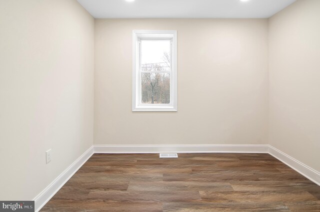 empty room with dark wood-type flooring