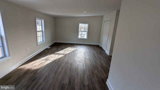 spare room with dark hardwood / wood-style floors