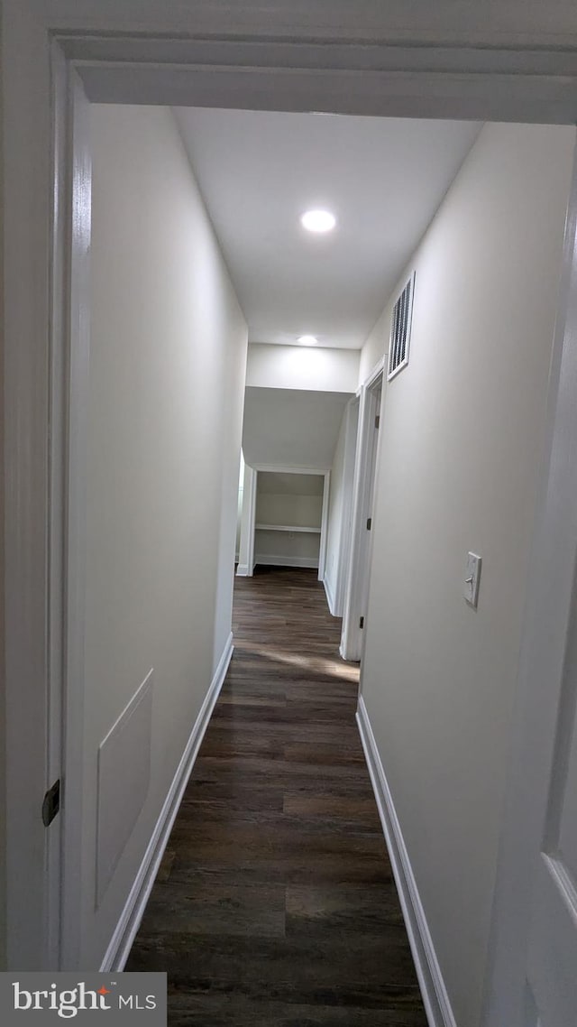 hallway with dark hardwood / wood-style floors