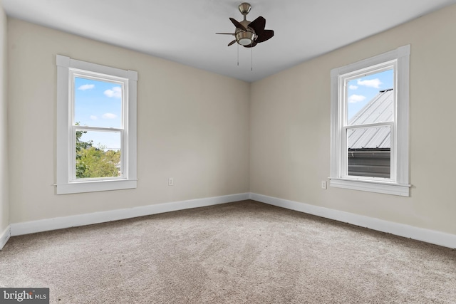 empty room featuring ceiling fan and carpet flooring