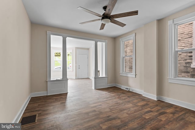 unfurnished room with ceiling fan and dark hardwood / wood-style flooring