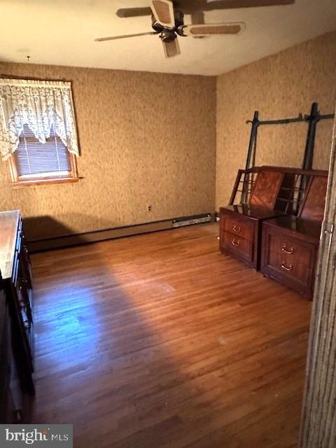 unfurnished bedroom featuring dark wood finished floors and a ceiling fan