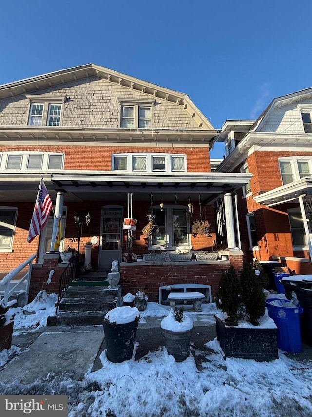 view of snow covered rear of property