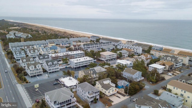 birds eye view of property featuring a beach view and a water view