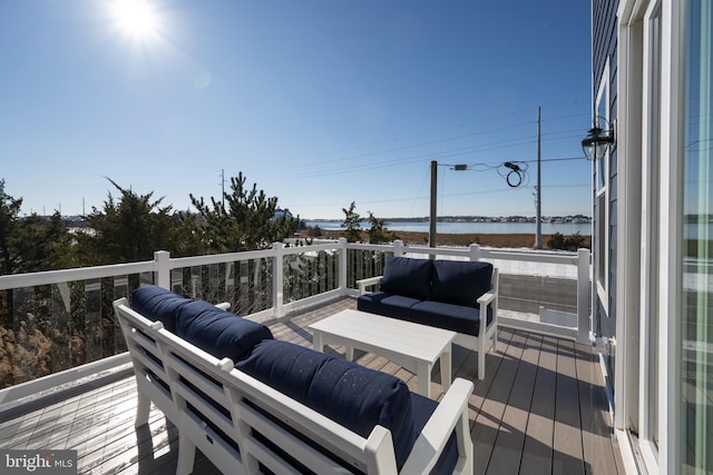 wooden deck featuring outdoor lounge area and a water view