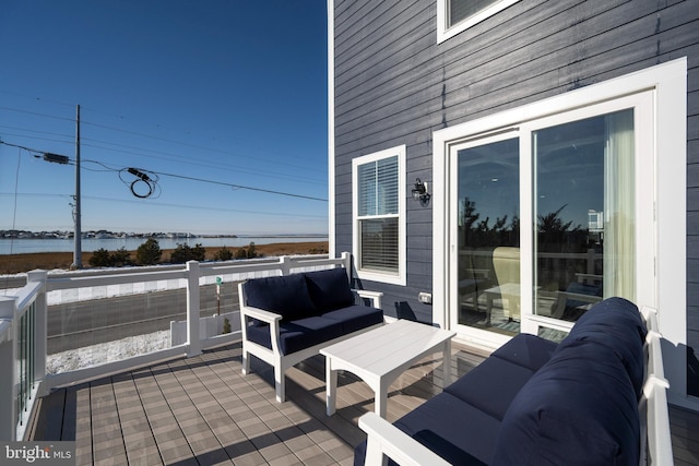 view of patio featuring a water view and an outdoor living space