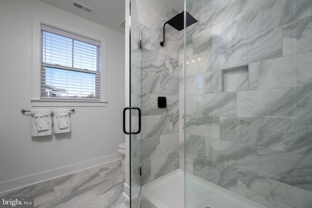 bathroom featuring an enclosed shower and toilet