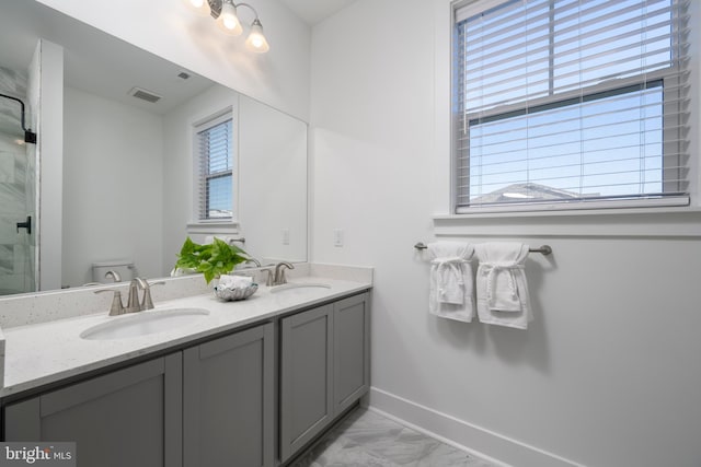 bathroom with toilet, a shower with door, and vanity