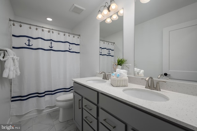 bathroom featuring toilet and vanity