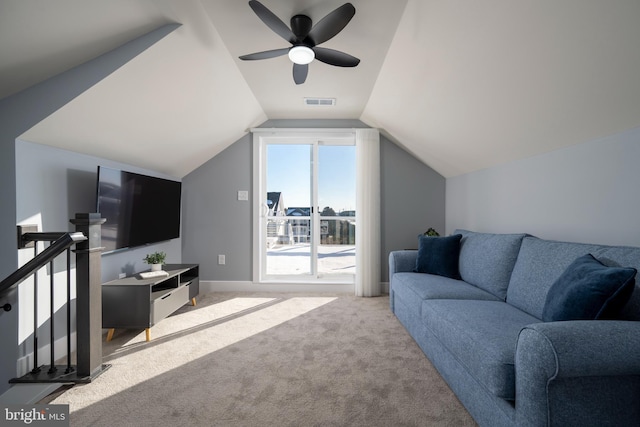 living room with lofted ceiling, ceiling fan, and light colored carpet