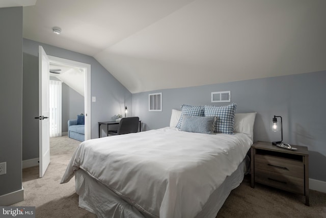 bedroom with light colored carpet and vaulted ceiling