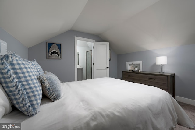 bedroom with lofted ceiling and carpet flooring