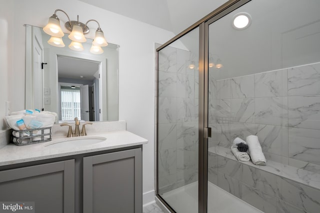 bathroom featuring an enclosed shower and vanity