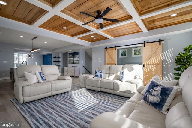 living room with dark hardwood / wood-style floors, wood ceiling, beam ceiling, a barn door, and coffered ceiling