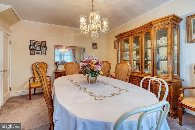 carpeted dining space featuring an inviting chandelier and ornamental molding