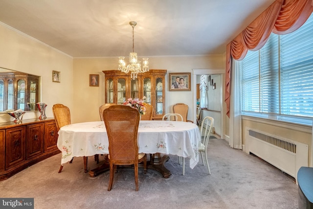 carpeted dining room with radiator, crown molding, and a notable chandelier