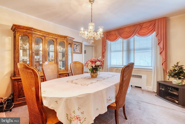 dining area with ornamental molding, a notable chandelier, radiator heating unit, and light carpet