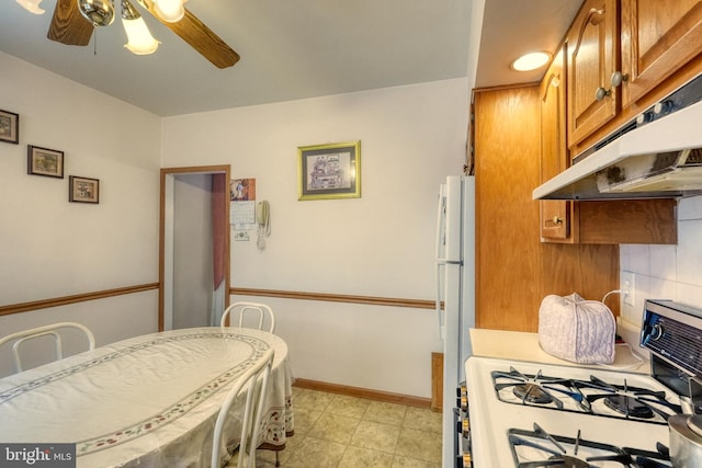 kitchen with white appliances and ceiling fan